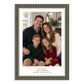 A personalized holiday photo card featuring a family portrait of four people, with a dark olive green and brown plaid border and custom text at the bottom 